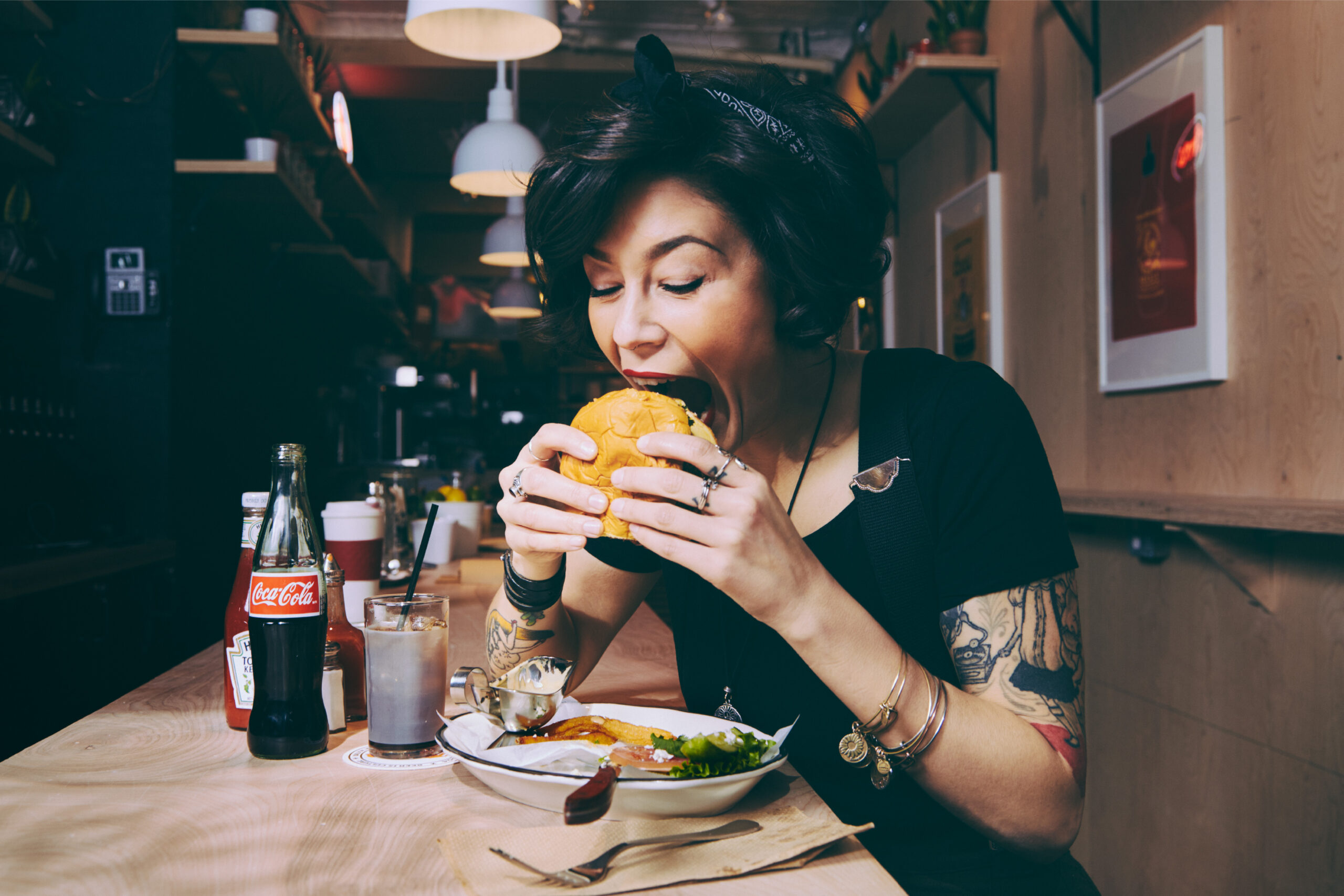 Photo of woman eating craft burger for Black Tap by Madonna+Child Creative Studio